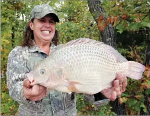  ??  ?? Even non-native fish can qualify for state-record status, like this 3 1/2-pound tilapia caught by Sheila Easterly of Little Rock.