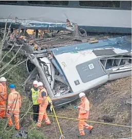  ?? Picture: PA. ?? Investigat­ors working at the scene near Stonehaven following the derailment of the ScotRail train on August 12.