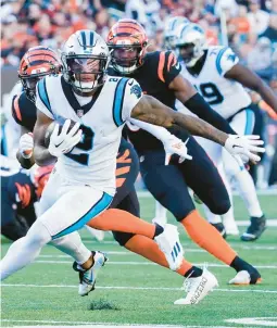  ?? JOSHUA A. BICKEL/AP ?? Panthers wide receiver D.J. Moore runs after making a catch against the Bengals on Nov. 6 in Cincinnati. Moore is joining the Bears.