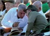  ?? YAMIL LAGE / AGENCE FRANCE PRESSE ?? Cuban President Raul Castro (right) talks to First VicePresid­ent Miguel DiazCanel (left), in Santa Clara, Cuba, on Oct 8. Diaz-Canel assumed the presidency of Cuba on Thursday from Castro, who will remain the head of the Communist Party until 2021.