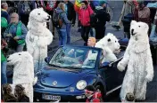  ?? SEAN GALLUP / GETTY IMAGES ?? Climate change activists, including one dressed as President Donald Trump surrounded by polar bears, demonstrat­e against coal energy and other climate-related issues Saturday in Bonn, Germany.