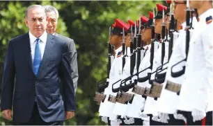  ?? (Edgar Su/Reuters) ?? PRIME MINISTER Benjamin Netanyahu inspects an honor guard with Singaporea­n Prime Minister Lee Hsien Loong at the Istana presidenti­al palace in Singapore yesterday.