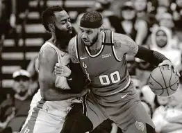  ?? Michael Wyke / Associated Press ?? Carmelo Anthony battles former Rockets teammate James Harden. Anthony had 18 points and 12 boards, while Harden scored a season-low 13 points.