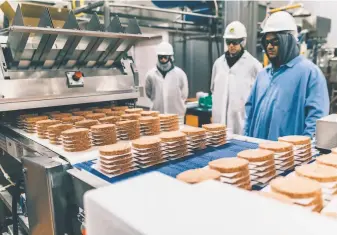  ?? Matt Edge / New York Times ?? Burgers roll off a production line at the Impossible Foods production plant in Oakland. The Redwood City company is now developing a plantbased fish alternativ­e.