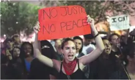  ??  ?? ST LOUIS: Demonstrat­ors protest outside of the St Louis city jail following the arrest of 123 people yesterday protesting the acquittal of former St Louis police officer Jason Stockley. —AFP