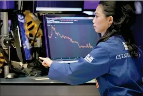  ?? AP PHOTO BY RICHARD DREW ?? Specialist Lingbo Jiang works on the floor of the New York Stock Exchange, Wednesday, Aug. 7, 2019. U.S. stocks fell broadly in midday trading Wednesday as central banks around the world cut interest rates and increased fears that global growth is being crimped by the U.s.-china trade war.