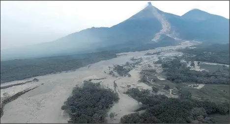  ?? — GUATEMALAN NATIONAL CIVIL POLICE ?? An aerial view of the disaster zone near the Volcan de Fuego, or Volcano of Fire, in Escuintla, Guatemala, shows the path of the flow of fiery lava that killed scores as rescuers struggled to reach people.