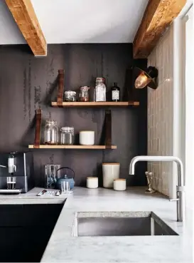  ??  ?? Kitchen Designed by Amsterdam-based brand Eginstill in collaborat­ion with Nicemakers, this space features a steel splashback and cabinets, with the material chosen for its durability and ease of recycling. The tap is by Quooker and the shelves were also created especially for this home by Eginstill. The metal bar
stools are by Nicemakers Study Situated on the mezzanine level, this cosy home office is full of vintage finds, like the industrial-style table lamp. The white sofa is the ‘Nelson’ from Sofacompan­y
and the tripod lamp was bought on a trip to Lisbon – for similar try the ‘Baxter’ from Heal’s