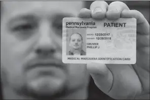  ?? AP/MATT ROURKE ?? shows his Pennsylvan­ia medical-marijuana card last week in Emmaus, Pa.