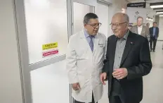  ?? LIAM RICHARDS ?? Dr. Ivar Mendez, head of surgery for the Saskatoon Health Region, left, speaks with Joe Remai, whose Joe Remai Family Foundation donated $1 million for the purchase of an O-arm scanning device.