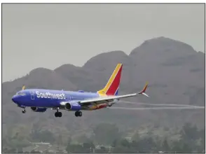  ?? (AP/Matt York) ?? A Southwest Airlines jet arrives at Sky Harbor Internatio­nal Airport on Wednesday in Phoenix. Travelers who counted on Southwest Airlines to get them home suffered another wave of canceled flights Wednesday and Thursday.