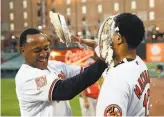  ?? Patrick Semansky / Associated Press ?? The Orioles’ Jonathan Schoop (left) hits teammate Manny Machado with a pie after Machado’s walk-off home run in the 12th.