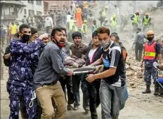  ?? Omar Havana/Getty Images ?? Emergency rescue workers carry a victim on a stretcher after Dharahara Tower in Kathmandu collapsed. The historic tower was a popular attraction with tourists and sightseers.
