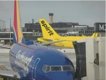  ?? BRIAN CASSELLA/CHICAGO TRIBUNE ?? Spirit Airlines and Southwest Airlines planes stand Feb. 14 at Terminal 5 of O’Hare Internatio­nal Airport in Chicago.