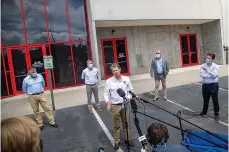  ?? Associated Press ?? ■ Governor Brian Kemp (center) makes a statement and answers questions May 15 following a tour of Fieldale Farms while visiting Gainesvill­e, GA.