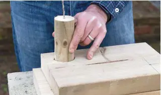  ??  ?? 5 Drill a pilot hole in the centre of your roof pillar using your 5mm drill bit. You can use the set saw hole to keep the post steady. In the opposite corner, drill a pilot hole 50mm in from the side and top edge.