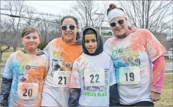 ??  ?? From left, Lukah Pothier, Jillian Veinot, Daeshawn Fletcher and Andrea Pothier, of Centrevill­e, were covered in bright colours at the end of A Run to Dye For.