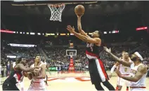  ??  ?? PORTLAND TRAIL BLAZERS guard CJ McCollum (3) attempts a shot in the fourth quarter of their game against the Atlanta Hawks at Philips Arena.