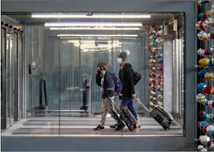  ?? AP FILE PHOTO/NAM Y. HUH ?? In this Sunday file photo, travelers walk through Terminal 3 at O’Hare Internatio­nal Airport in Chicago.