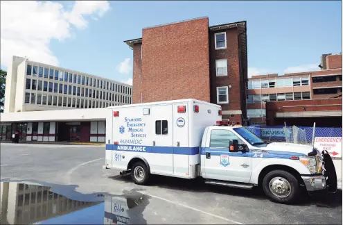  ?? Michael Cummo / Hearst Connecticu­t Media ?? An ambulance waits at Stamford Hospital in July 2016. Connecticu­t hospitals and health care providers have received roughly $1 billion in federal coronaviru­s direct payments, but as the pandemic continues to surge, they’re advocating for more relief.