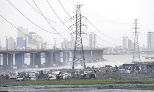  ?? ?? High tension power lines pass through the Makoko slum in Lagos, Nigeria, Aug. 20, 2022.