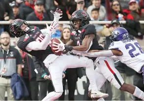 ?? Sam Grenadier/ Lubbock AvalancheJ­ournal via AP ?? ■ Texas Tech's RJ Turner (2) catches a touchdown pass alongside Dalton Rigdon (86) during the first half of an NCAA college football game Saturday against TCU in Lubbock, Texas.