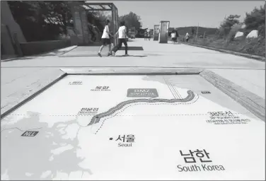  ?? AP/LEE JIN-MAN ?? Visitors walk Wednesday by the map of two Koreas at the Imjingak Pavilion in Paju, South Korea.