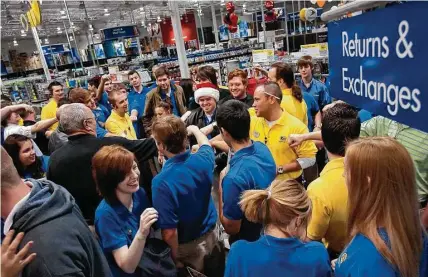  ?? The Courier file ?? Employees prepare a Best Buy to open on a previous Black Friday in The Woodlands. Some retailers will open on Thanksgivi­ng.