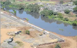  ??  ?? Constructi­on of a wall along Waldhuni river at Gauripada, Kalyan (W).