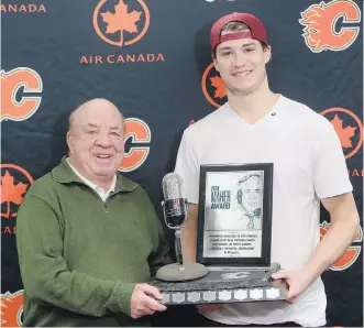  ?? CHRISTINA RYAN/ CALGARY HERALD ?? Peter Maher presents Calgary Flames forward Joe Colborne with the Peter Maher Award for the second year in a row at the Scotiabank Saddledome on Wednesday.