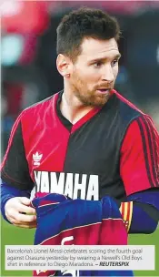  ??  ?? Barcelona’s Lionel Messi celebrates scoring the fourth goal against Osasuna yesterday by wearing a Newell’s Old Boys shirt in reference to Diego Maradona.