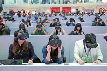  ?? PROVIDED TO CHINA DAILY ?? People wearing VR headsets are invited to join a VR shopping experience on Nov 11 at Shenzhen Dayun Arena. The event was launched by Tmall, an online marketplac­e of Alibaba.