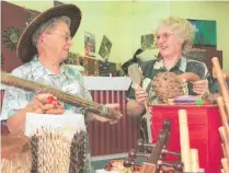  ?? ?? Napier shop volunteers Betty Smith (left) and Jenny Marsden demonstrat­ing musical instrument­s to celebrate Trade Aid’s 25th birthday.