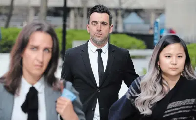  ?? STEVE RUSSELL TORONTO STAR ?? Jacob Hoggard leaves court Thursday with his lawyers Megan Savard and Kally Ho after the first day of testimony in his trial. He is accused of sexually assaulting two women at Ontario hotels in separate incidents in 2016. He has pleaded not guilty.