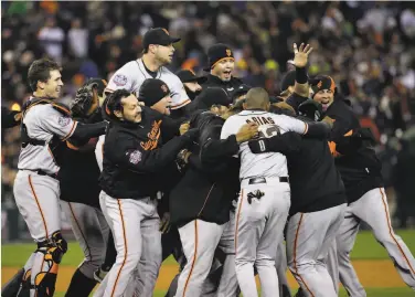  ?? David J. Phillip / Associated Press 2012 ?? The Giants celebrate on the field after winning Game 4 of the 2012 World Series against the Detroit Tigers.