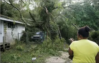  ?? AP PHOTO/GERALD HERBERT ?? Seleka Souls looks over a neighbor’s home that was damaged by Hurricane Sally, Friday, in Pensacola, Fla.