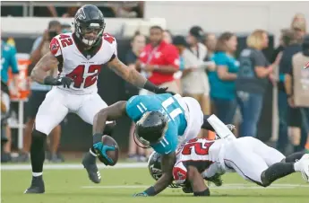  ?? AP ?? Jaguars receiver Marqise Lee suffers an injured left knee on a tackle by Falcons cornerback Damontae Kazee.