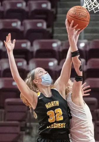  ?? Emily Matthews/Post-Gazette ?? North Allegheny’s Lizzy Groetsch, left, and Spring-Ford’s Lucy Olsen reach for a rebound. Groetsch led the Tigers with 22 points.