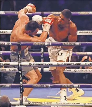  ?? MATT DUNHAM, AP ?? Anthony Joshua delivers a blow to Wladimir Klitschko on his way to a TKO victory Saturday in London.