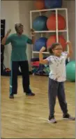  ?? MICHILEA PATTERSON — FOR DIGITAL FIRST MEDIA ?? Ayania Warrick, 8, smiles big as she does exercises during a family Zumba fitness class at the Pottstown YMCA. Warrick and her mom participat­ed in the class demonstrat­ion during the Y’s re-opening and open house celebratio­n. Hyalene Nash, 73, and Ayania Warrick, 8, exercise during a Zumba class demonstrat­ion in the newly renovated Pottstown YMCA fitness studio.