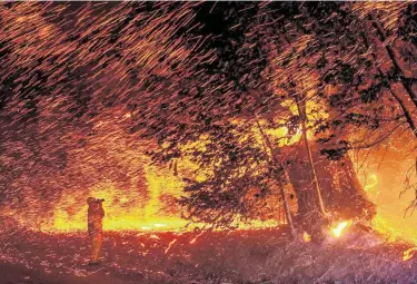  ?? Josh Edelson / AFP via Getty Images ?? Winds whip up embers as flames rip through the area Thursday during the Kincade fire near Geyservill­e, Calif. The blaze that started Wednesday night exploded to a 10,000-acre inferno.