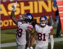  ?? SUSANWALSH - THE ASSOCIATED PRESS ?? New York Giants tight end Evan Engram (88) pointing upwards after scoring a touchdown against the Washington Football Team, Sunday, Nov. 8, 2020, in Landover, Md. Also on the field is teammate wide receiver Austin Mack (81).