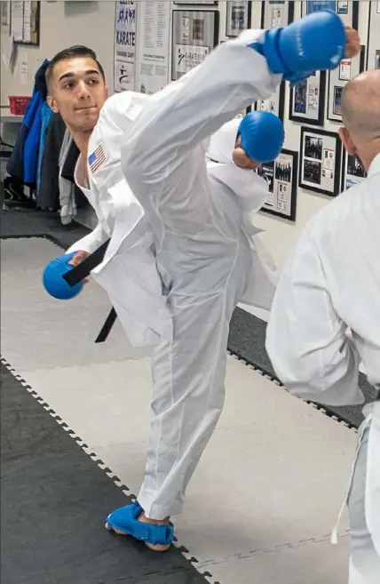  ?? Alexandra Wimley/Post-Gazette ?? Jared Smith, a senior at Franklin Regional, works out at Pennsylvan­ia Shotokan Karate in Leetsdale.