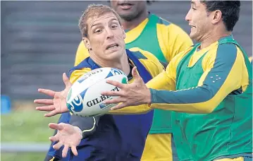  ?? AP ?? Australia’s Dan Vickerman, left, and Anthony Fainga’a, right, compete for the ball during a training session.