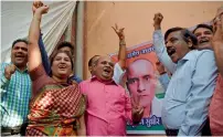  ?? AFP ?? Friends of Kulbhushan react after he was given a stay of execution in the neighbourh­ood where he grew up in Mumbai. —