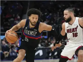  ?? PAUL SANCYA — THE ASSOCIATED PRESS ?? Pistons guard Cade Cunningham drives on Heat forward Caleb Martin in the second half on Friday in Detroit.