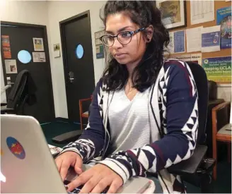  ??  ?? Janik Shah, a student counselor in UCLA’s Peer Resilience Network, part of the school’s Depression Grand Challenge, reviews online mental health evaluation­s submitted voluntaril­y by students. The evaluation­s are offered to every student, and...