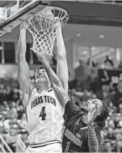  ?? Brad Tollefson / Associated Press ?? Texas Tech’s Daniel Batcho dunks over Arkansas State’s Markise Davis during the Red Raiders’ win.