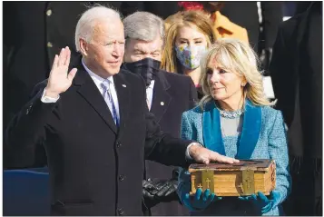  ?? (AP Photo/Andrew Harnik) ?? Joe Biden is sworn in as the 46th president of the United States by Chief Justice John Roberts as Jill Biden holds the Bible during the 59th Presidenti­al Inaugurati­on Jan. 20. Biden used the same 1893 family Bible he has used twice when being sworn in as vice president and seven times as senator from Delaware.