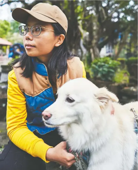  ?? PHOTOS: AN RONG XU/THE WASHINGTON POST ?? Pet psychic Yoyo Hsu communicat­es with her dog, Coffee, in Taipei, Taiwan. The island is home to one of the world's most active communitie­s of animal communicat­ors, while pet ownership of cats and dogs has almost doubled in recent years.